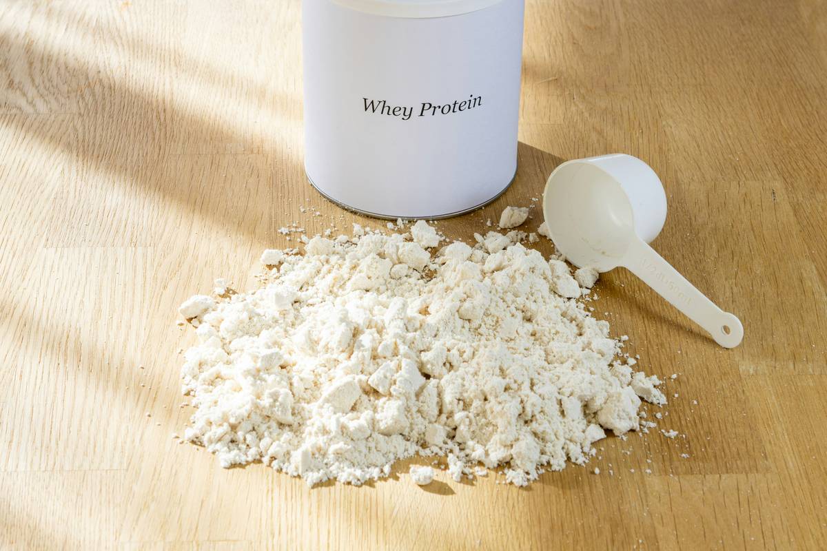benefits of taking collagen supplements: woman applying serum while holding collagen powder jar