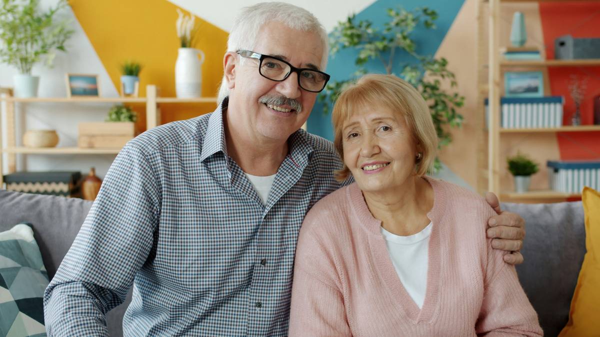 Senior woman smiling while holding a jar of collagen powder—illustrating benefits of collagen supplements for seniors